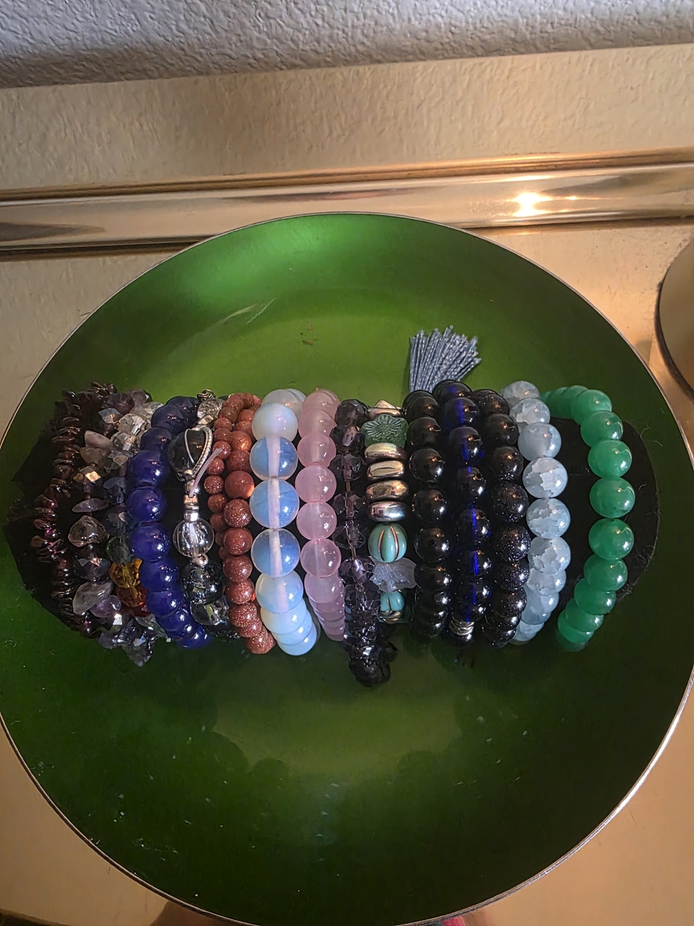 Stack of Assorted Beaded Women’s Bracelets in Green, Black, Pink, Blue and White